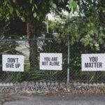 don't give up. You are not alone, you matter signage on metal fence